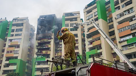 A firefighter douses a fire that broke out in Green Avenue Society, Indirapuram, Ghaziabad, Wednesday, April 29, 2026. 