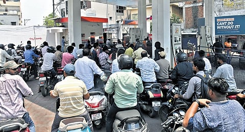 Motorists wait to get their two-wheelers refuelled at a petrol bunk in Amberpet on Tuesday.