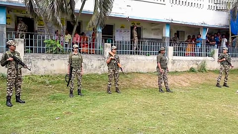 Security personnel stand guard during voting in the second and final phase of the West Bengal Assembly elections, in Khanakul, Hooghly district, Wednesday, April 29, 2026. 