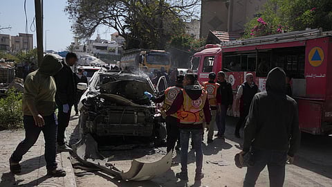 Palestinian civil defense crews work on a destroyed car after it was struck in an Israeli strike in Gaza City Tuesday, April 28, 2026