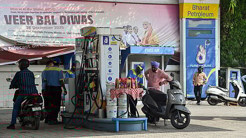 A petrol pump staff refills fuel in a vehicle amid rising fuel prices in New Delhi.