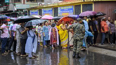 Howrah: People wait in queues amid rain before casting their votes in the second and final phase of the West Bengal Assembly elections, at a polling station in Howrah, Wednesday, April 29, 2026. 