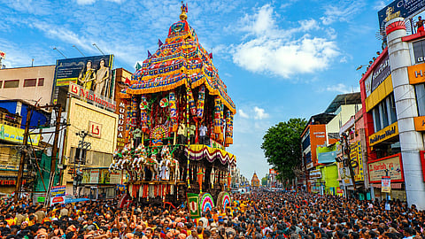 Devotees are seen pulling the massive car on Wednesday in Maasi street during the Chithirai Car festival of Madurai Meenakshi Sundereswarar Temple.