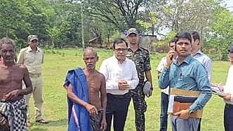 RDC Sangram Keshari Mohapatra(centre) along with officials during his visit to Jitu Munda (with towel on shoulder) at Dianali village in Keonjhar district
