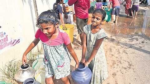 Children carry pots of drinking water from a panchayat supply tanker in Anchuthengu, amid worsening water crisis in Thiruvananthapuram.
