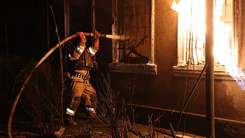 In this photo provided by the Ukrainian Emergency Service, firefighters put out a fire in a residential building following a Russian drone attack in Mykolayiv, Ukraine, Friday, May 1, 2026.
