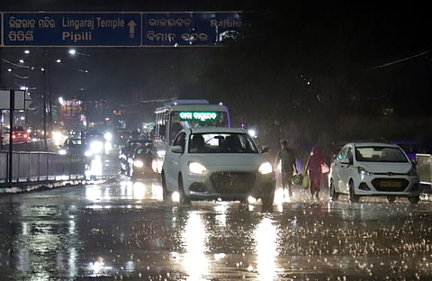 Vehicles moving amid heavy rain in Bhubaneswar on Thursday evening 