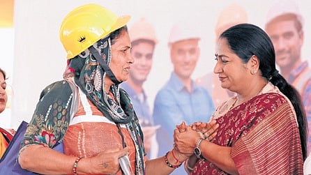 Chief Minister Rekha Gupta interacts with a construction worker on Friday | X