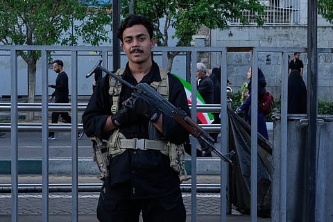 A security personnel stands guard in a state-organised rally celebrating the birthday of Imam Reza, the 8th Shiite Muslims' Imam, and supporting the Supreme Leader Ayatollah Mojtaba Khamenei, in Tehran, Iran, Wednesday, April 29, 2026. 
