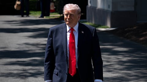 President Donald Trump walks to speak with reporters as he prepares to board Marine One on the South Lawn of the White House, Friday, May 1, 2026, in Washington. 