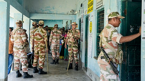 Security personnel stand guard at a polling station during a repoll ordered by the Election Commission following reports of electoral malpractices, at Magrahat Paschim constituency, in South 24 Parganas district, West Bengal, Saturday, May 2, 2026. 