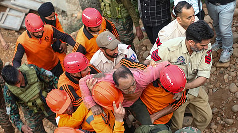 A worker being rescued from the rubble after an under-construction bridge collapsed on Bantalab Road, on the outskirts of Jammu, Friday, May 1, 2026.