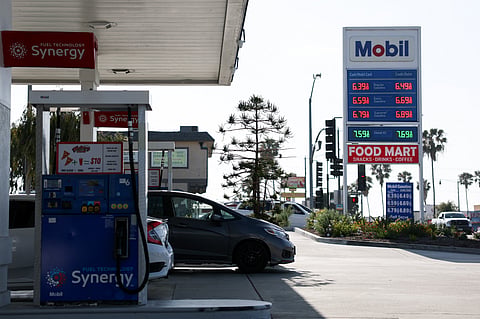 Vehicles sit parked at fuel pumps as regular gasoline prices above $6 per gallon and diesel prices above $7 per gallon are displayed outside a Mobil gas station in Redondo Beach, California on April 30, 2026.