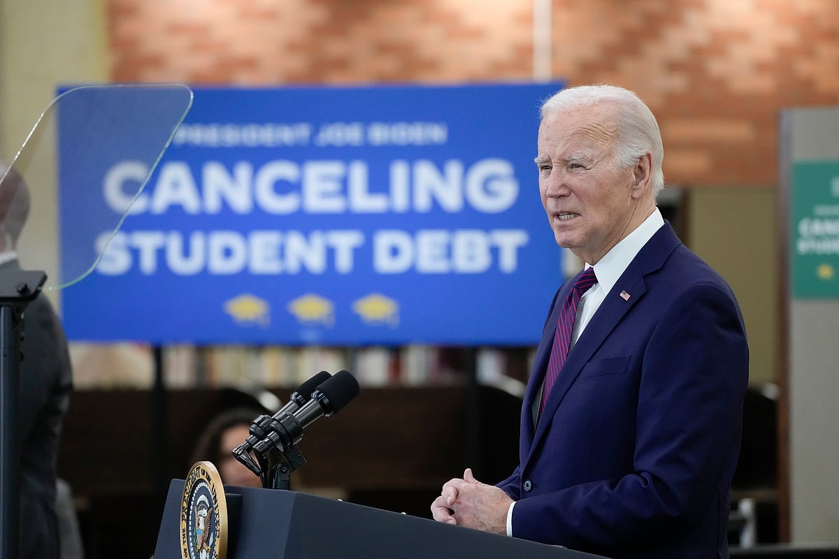 Biden says too many Americans are saddled with school debt as he